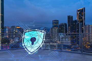 Rooftop with concrete terrace, Kuala Lumpur night skyline. Cyber security concept to protect clients confidential information. IT hologram padlock icons. City downtown. Double exposure.