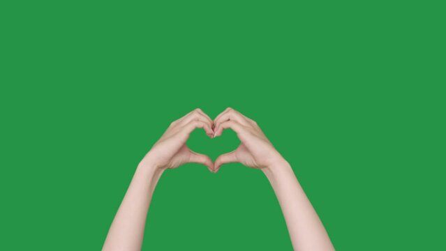 Love gesture. Charity donation. Care support. Female hands showing compassion making beating heart shape isolated on green chroma key empty space background set of 2.