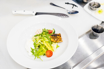 in a white plate lettuce green and tomato