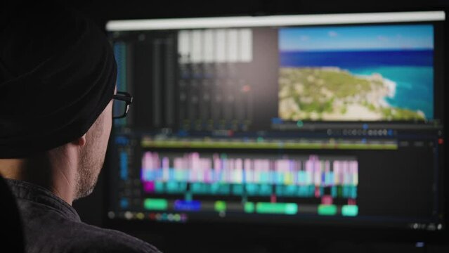 Experienced video editor working on a big project. A man edits a blog or a movie. Freelance