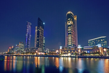 Skyscrapers including the Crown Plaza Casino complex on the shoreline of the River Yarra in Melbourne - obrazy, fototapety, plakaty