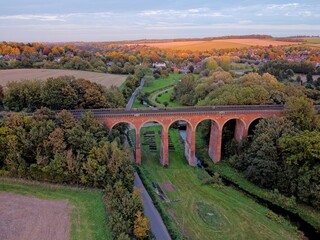 Aerial drone view of Eynsford viaduct, arched brick bridge for railway tracks over the river...