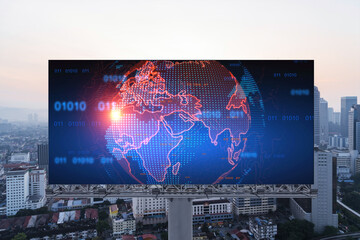 Glowing hologram of Earth planet map on billboard over aerial panoramic cityscape of Kuala Lumpur at sunset, Malaysia, Asia. The concept of international business in KL.