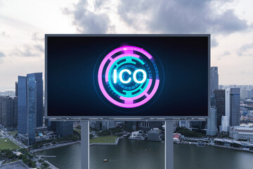 ICO hologram icon on billboard over panorama city view of Singapore at sunset. The hub of...