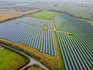 Fototapeta na wymiar Aerial drone shot. Solar panels farm in a field near Sittingbourne in Kent, England.