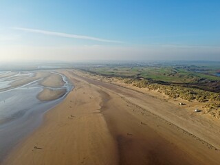 Aerial drone. Camber Sands in East Sussex. Popular seaside destination with large sandy beach and surfing spot in England.