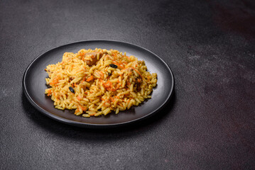 Pilaf or pilau with chicken, traditional uzbek hot dish of boiled rice, chicken meat, vegetables and spices