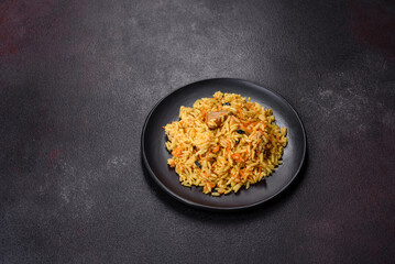 Pilaf or pilau with chicken, traditional uzbek hot dish of boiled rice, chicken meat, vegetables and spices