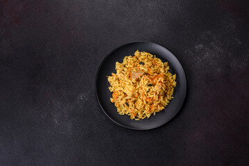 Pilaf or pilau with chicken, traditional uzbek hot dish of boiled rice, chicken meat, vegetables and spices