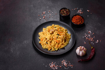 Pilaf or pilau with chicken, traditional uzbek hot dish of boiled rice, chicken meat, vegetables and spices