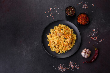 Pilaf or pilau with chicken, traditional uzbek hot dish of boiled rice, chicken meat, vegetables and spices