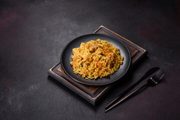 Pilaf or pilau with chicken, traditional uzbek hot dish of boiled rice, chicken meat, vegetables and spices