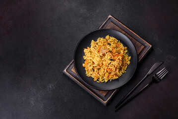 Pilaf or pilau with chicken, traditional uzbek hot dish of boiled rice, chicken meat, vegetables and spices
