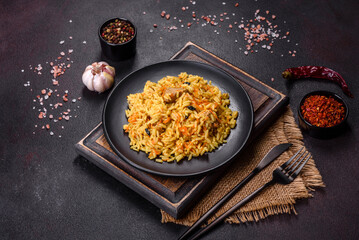 Pilaf or pilau with chicken, traditional uzbek hot dish of boiled rice, chicken meat, vegetables and spices