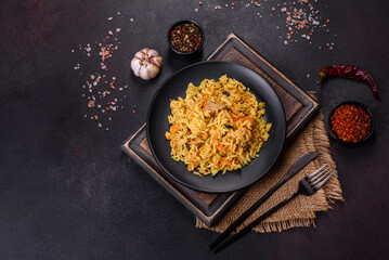 Pilaf or pilau with chicken, traditional uzbek hot dish of boiled rice, chicken meat, vegetables and spices