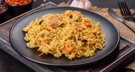 Pilaf or pilau with chicken, traditional uzbek hot dish of boiled rice, chicken meat, vegetables and spices