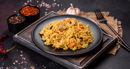 Pilaf or pilau with chicken, traditional uzbek hot dish of boiled rice, chicken meat, vegetables and spices