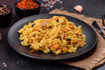 Pilaf or pilau with chicken, traditional uzbek hot dish of boiled rice, chicken meat, vegetables and spices