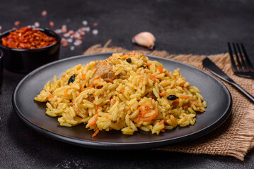 Pilaf or pilau with chicken, traditional uzbek hot dish of boiled rice, chicken meat, vegetables and spices