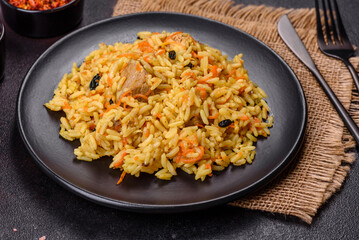 Pilaf or pilau with chicken, traditional uzbek hot dish of boiled rice, chicken meat, vegetables and spices