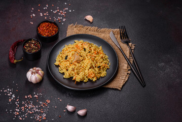 Pilaf or pilau with chicken, traditional uzbek hot dish of boiled rice, chicken meat, vegetables and spices