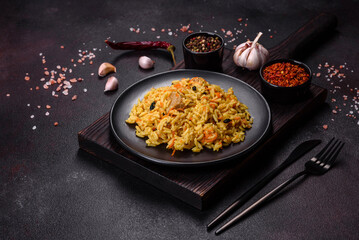 Pilaf or pilau with chicken, traditional uzbek hot dish of boiled rice, chicken meat, vegetables and spices