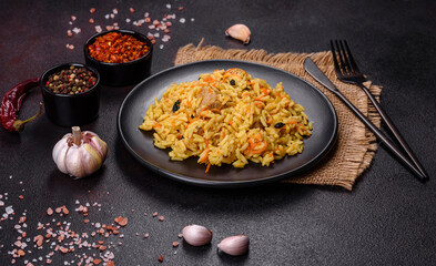 Pilaf or pilau with chicken, traditional uzbek hot dish of boiled rice, chicken meat, vegetables and spices