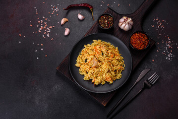 Pilaf or pilau with chicken, traditional uzbek hot dish of boiled rice, chicken meat, vegetables and spices