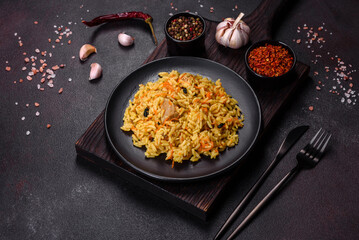 Pilaf or pilau with chicken, traditional uzbek hot dish of boiled rice, chicken meat, vegetables and spices