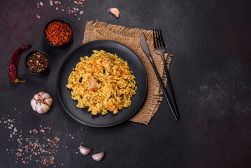 Pilaf or pilau with chicken, traditional uzbek hot dish of boiled rice, chicken meat, vegetables and spices
