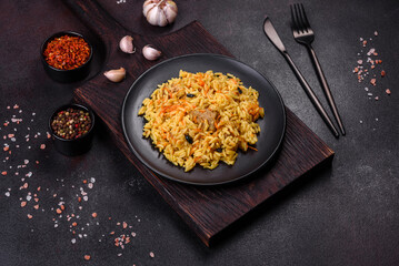 Pilaf or pilau with chicken, traditional uzbek hot dish of boiled rice, chicken meat, vegetables and spices