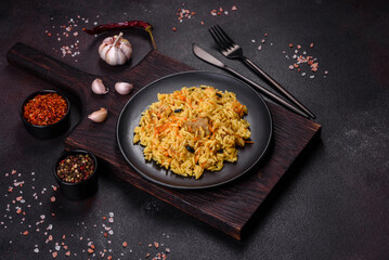 Pilaf or pilau with chicken, traditional uzbek hot dish of boiled rice, chicken meat, vegetables and spices