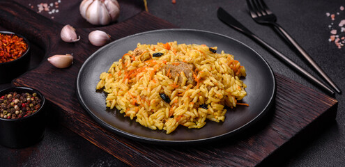 Pilaf or pilau with chicken, traditional uzbek hot dish of boiled rice, chicken meat, vegetables and spices