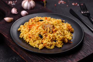 Pilaf or pilau with chicken, traditional uzbek hot dish of boiled rice, chicken meat, vegetables and spices