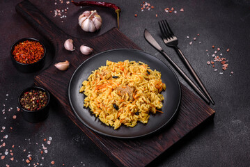 Pilaf or pilau with chicken, traditional uzbek hot dish of boiled rice, chicken meat, vegetables and spices