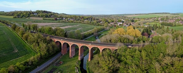 Aerial drone view of Eynsford viaduct, arched brick bridge for railway tracks over the river Darent. Kent, England, UK.