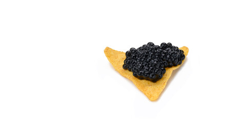 Triangular nachos with black paddlefish caviar isolated on white background. Snack