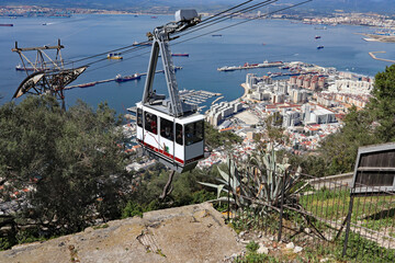 Panoramic view over Gibraltar harbour and a cable car from the top of the Rock of Gibraltar. - obrazy, fototapety, plakaty