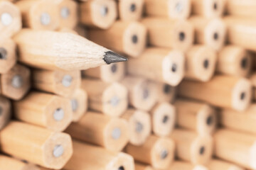 image of a sharp simple wooden pencil against other pencils, symbolizing a concept that stands out...