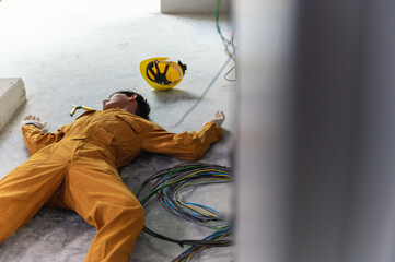 Accident from work of electrician or maintenance worker lying unconscious on floor near the electric wire in the factory control room after the shock. Electronic Injury concept