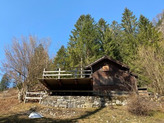 Mountain huts (chalets) or farmhouses and old wooden cattle houses in the alpine valley of Kl&ouml;ntal (or Kloental) and by the resevoir lake Kl&ouml;ntalersee (Kloentalersee) - Canton of Glarus, Switzerland
