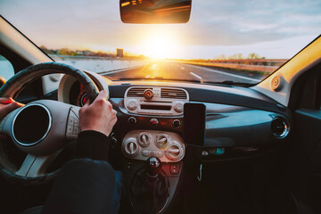 Naklejka premium Rear view of man driving car on the highway - Transportation lifestyle concept