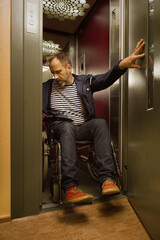 Obraz na płótnie Canvas Disabled man on wheel chair using elevator in apartment house