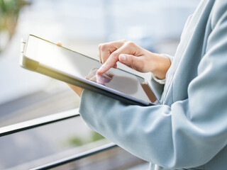 Business made easier with technology. Shot of an unrecognizable businesswoman using a digital...