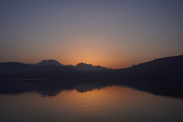 Fototapeta na wymiar Orange sunset over the sea with reflection