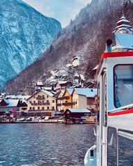 Ferry across a lake in the Alps to the city of Hallstatt in Austria. View from the ferry to Hallstatt.