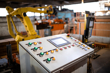 Close up view on industrial computer and control panel switchboard for operating manufacturing machines. Factory interior.