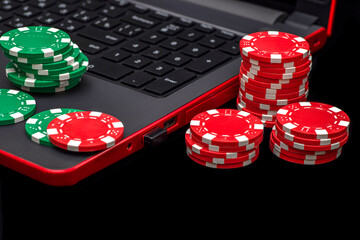 Gambling online casino Internet betting concept. Jackpot, casino chips. computer keyboard, laptop with poker chips, dice. Casino tokens, gaming chips, checks, or cheques
