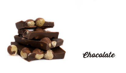 Chocolate pieces with hazelnuts on a white background