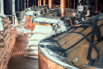 Brewery equipment. Brew manufacturing. Round cooper storage tanks for beer fermentation and maturation.